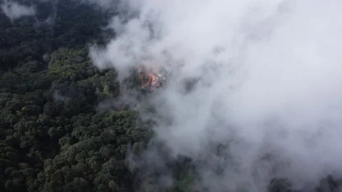 Aerial view from a drone flying over a foggy rural village in winter. 動画素材 222468372