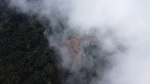 Aerial view from a drone flying over a foggy rural village in winter. Stock Footage 222468402