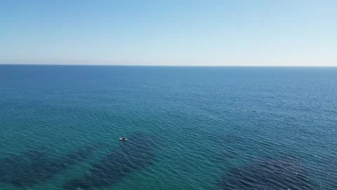 Aerial view from a drone flying over people on paddle boards, seascape, 4K Stock Footage 274856221