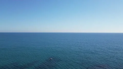 Aerial view from a drone flying over people on paddle boards, seascape, 4K Stock Footage 274856229