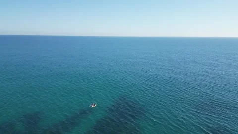 Aerial view from a drone flying over people on paddle boards, seascape, 4K Stock Footage 274856237