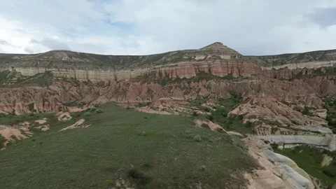 Aerial view of a drone flying over a small green plain in the middle of Rose Val 스톡 동영상 336484198