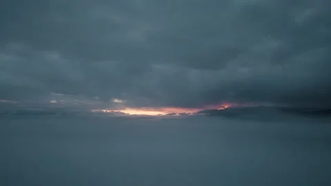 Aerial view from drone flying through misty clouds at sunrise Stock Footage 323619290