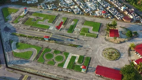 Aerial view, drone flyover and around driving training institution next to Stock Footage 279090489