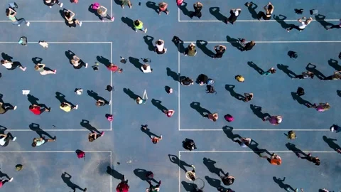 Aerial view from a drone to a group of people who are engaged in gymnastics and Stock Footage 164793662