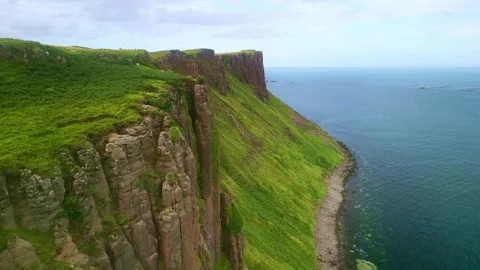Aerial view drone Isle of Skye in Scotland. Coastal sea cliffs, sheep on pasture Stock Footage 256360795