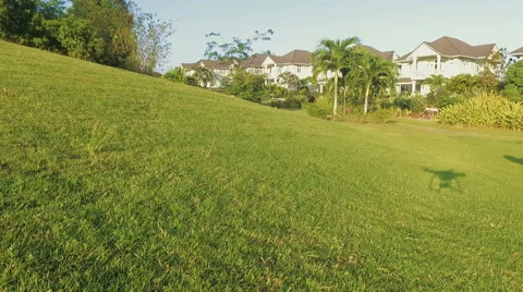 Aerial view from drone landing with shadow in lawn in suburban neighborhood. Stock Footage 61445945