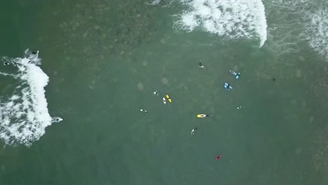 Aerial view with drone looking down of several surfers in the sea 库存影片 143385253