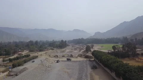 Aerial view with drone of men working in a dry river with machines Stock Footage 143936736
