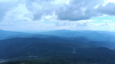 Aerial view from drone on mountain forest and peak of blue rock range. Stock Footage 141025412