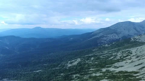 Aerial view from drone on mountain forest and peak of blue rock range. Stock Footage 141025413
