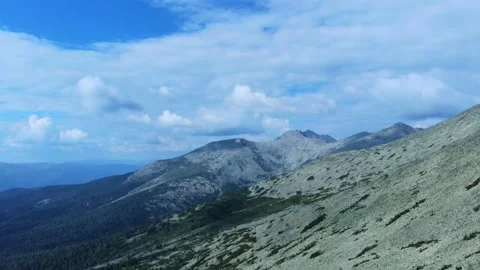 Aerial view from drone on mountain forest and peak of blue rock range. Stock Footage 141025875