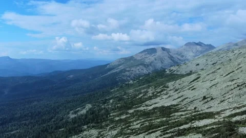 Aerial view from drone on mountain forest and peak of blue rock range. Stock Footage 141025901