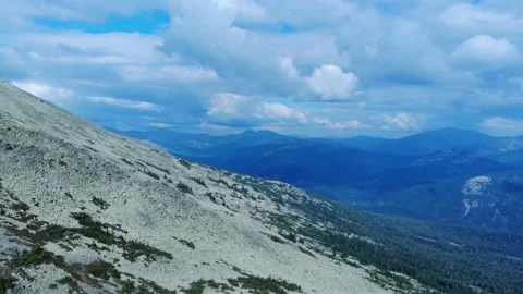 Aerial view from drone on mountain forest and peak of blue rock range. Stock Footage 141026079