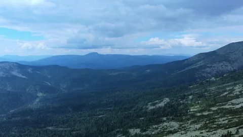 Aerial view from drone on mountain forest and peak of blue rock range. Stock Footage 141026457