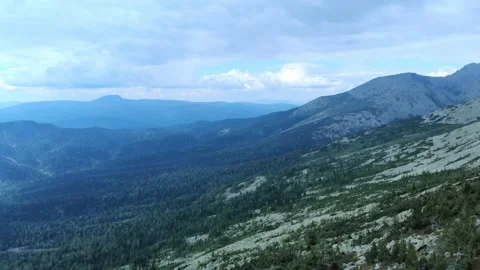 Aerial view from drone on mountain forest and peak of blue rock range. Stock Footage 141026460