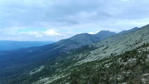 Aerial view from drone on mountain forest and peak of blue rock range. Stock Footage 141026509
