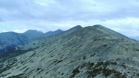 Aerial view from drone on mountain forest and peak of blue rock range. Stock Footage 141026549