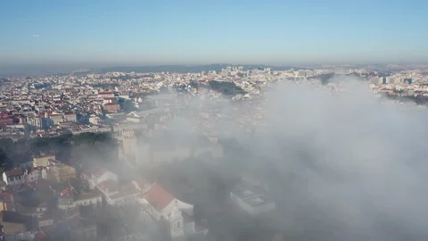 Aerial view; drone moves down in the mist over the rooftops Stock Footage 105292458