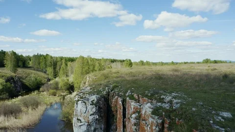 Aerial view; drone moving backward down opposite stone slope Stock Footage 109329252