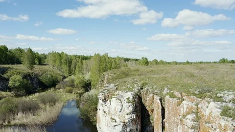 Aerial view; drone moving backward down opposite stone slope Stock Footage 109329633