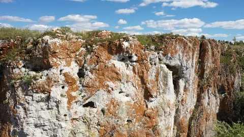 Aerial view; drone moving backward down opposite stone slope Stock Footage 109330722
