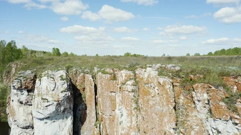 Aerial view; drone moving backward down opposite stone slope Stock Footage 109331210