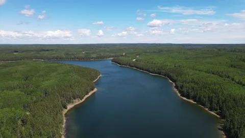 Aerial view from a drone moving forward over a dark blue colored lake  Stock Footage 275833954
