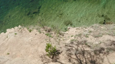 Aerial view; drone moving over the transparent water of mountain lake Stock Footage 110170987