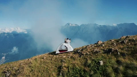 Aerial view; drone moving over resting couple Stock Footage 117408269