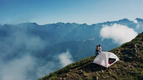 Aerial view; drone moving over resting couple Stock Footage 117409733