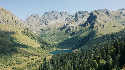 Aerial view; drone moving over mountain lake with torquoise water Stock Footage 120845547