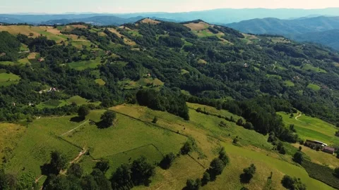 Aerial view drone orbiting and panning right over green hills and valley Serbia Stock Footage 342242251