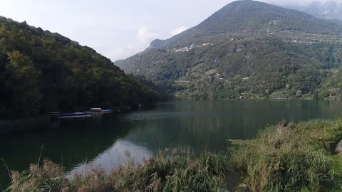 Aerial view with drone over a blue lake in Val Camonica Italy Stock Footage 99729310