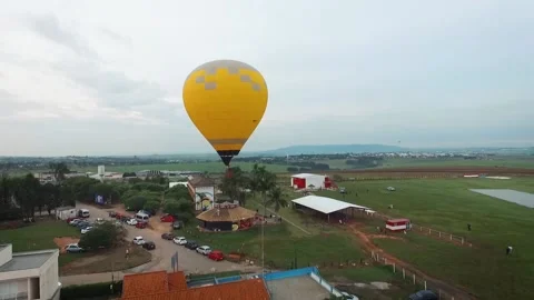 Aerial view with drone passing next to a yellow hot air balloon, at the Stock Footage 130652080