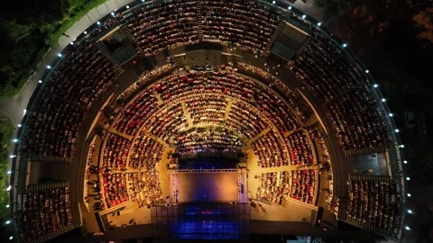 Aerial view with drone of people watching concert in open air theater Stock Footage 246563334