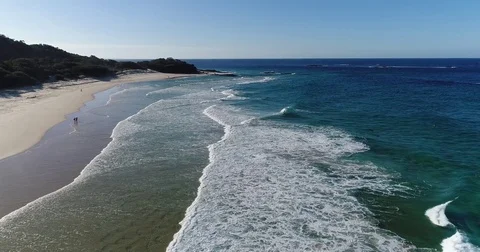Aerial view by drone of rolling beach waves on a sunny day Vídeo Stock 78328076