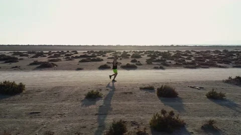 Aerial view from drone of runner jogging in desert Stock Footage 132166921