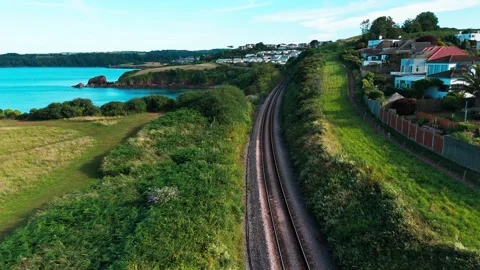 Aerial view drone shot of devon coastline, railway and housing Stock Footage 337880812