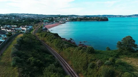 Aerial view drone shot of devon coastine, housing and historical railway lin Stock Footage 337880822