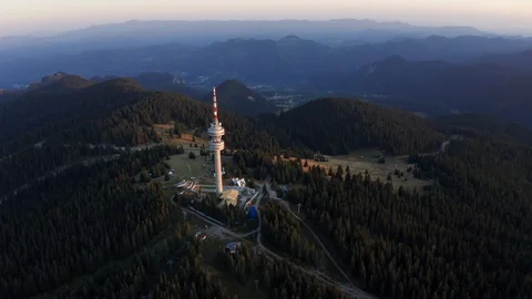 Aerial view from drone slide forward on tower structure high in mountains Stock Footage 123537443