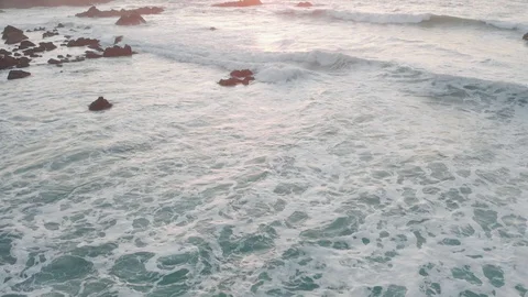 Aerial view of drone slide over sea surface in sun light, golden hour sunset Stock Footage 128630689