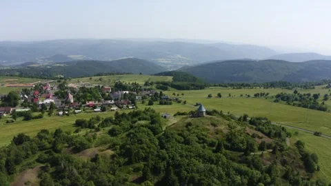 Aerial view from a drone - a small old building with a cone-shaped roof on a Vídeo Stock 246325011