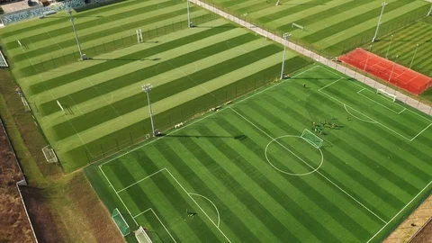 Aerial view of a drone of soccer fields and silhouettes of soccer players Stock Footage 106376020