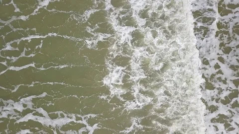 An aerial view from a drone of strong waves hitting shoreline Stock Footage 81216802