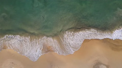 Aerial view of drone. Sunsets over sea. Beautiful sea waves. Beach sand and amaz 動画素材 143002968