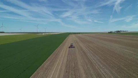 Aerial view by drone of tractor plowing the land in the windmills Stockbeeldmateriaal 166309824
