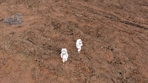 Aerial view by drone of two astronauts walking on volcanic land, Hawaii Vidéo 100073334