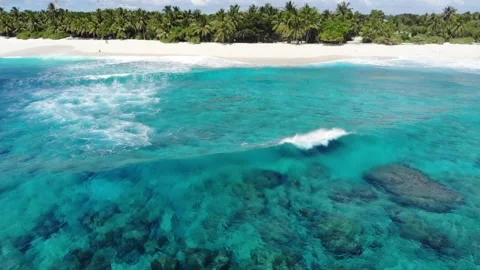 Aerial View Drone Video of waves crashing on the beach in Fuvahmulah in Maldives Stock Footage 146183674