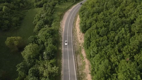 Aerial view drone view on automobile on the road trough the trees in mounta.. Stock Footage 242198300